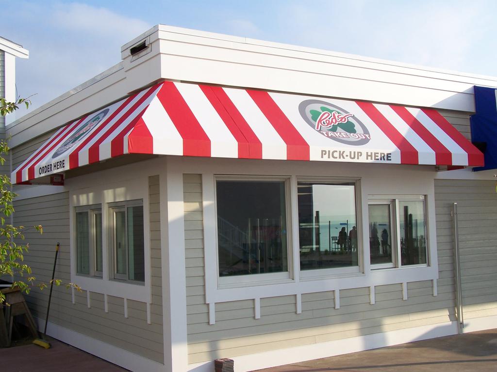 CommercialStoreFrontAwnings3 striped awnings outside of commercial building