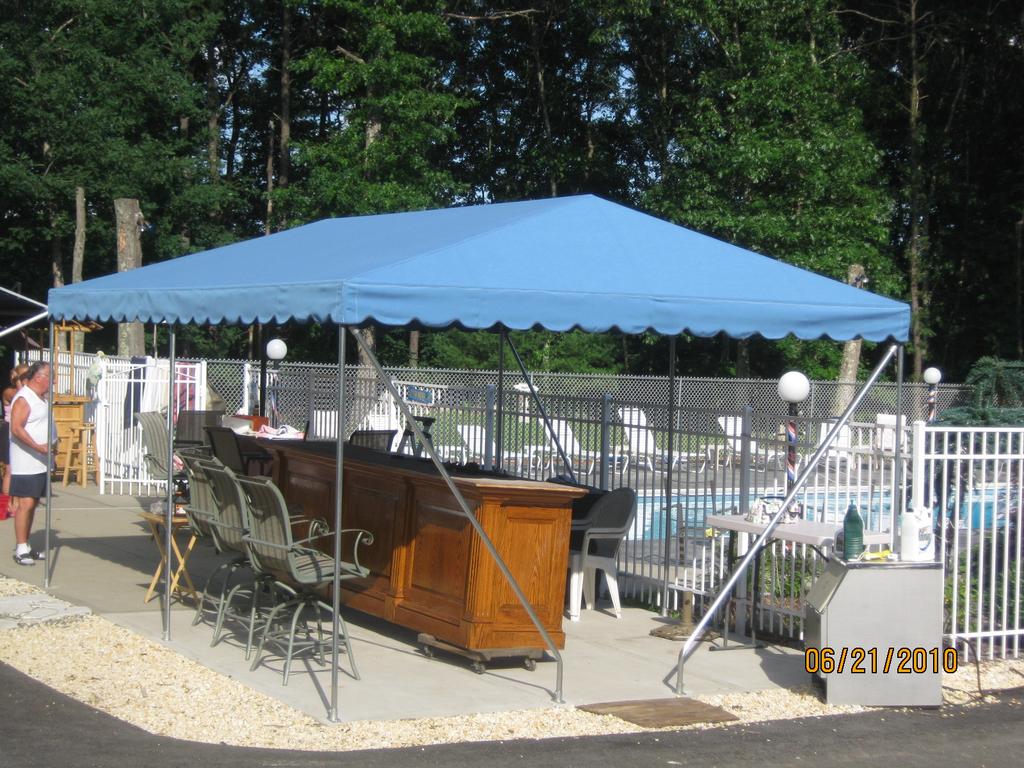 PoolsideAndYardAwnings4 striped awnings outside of commercial building