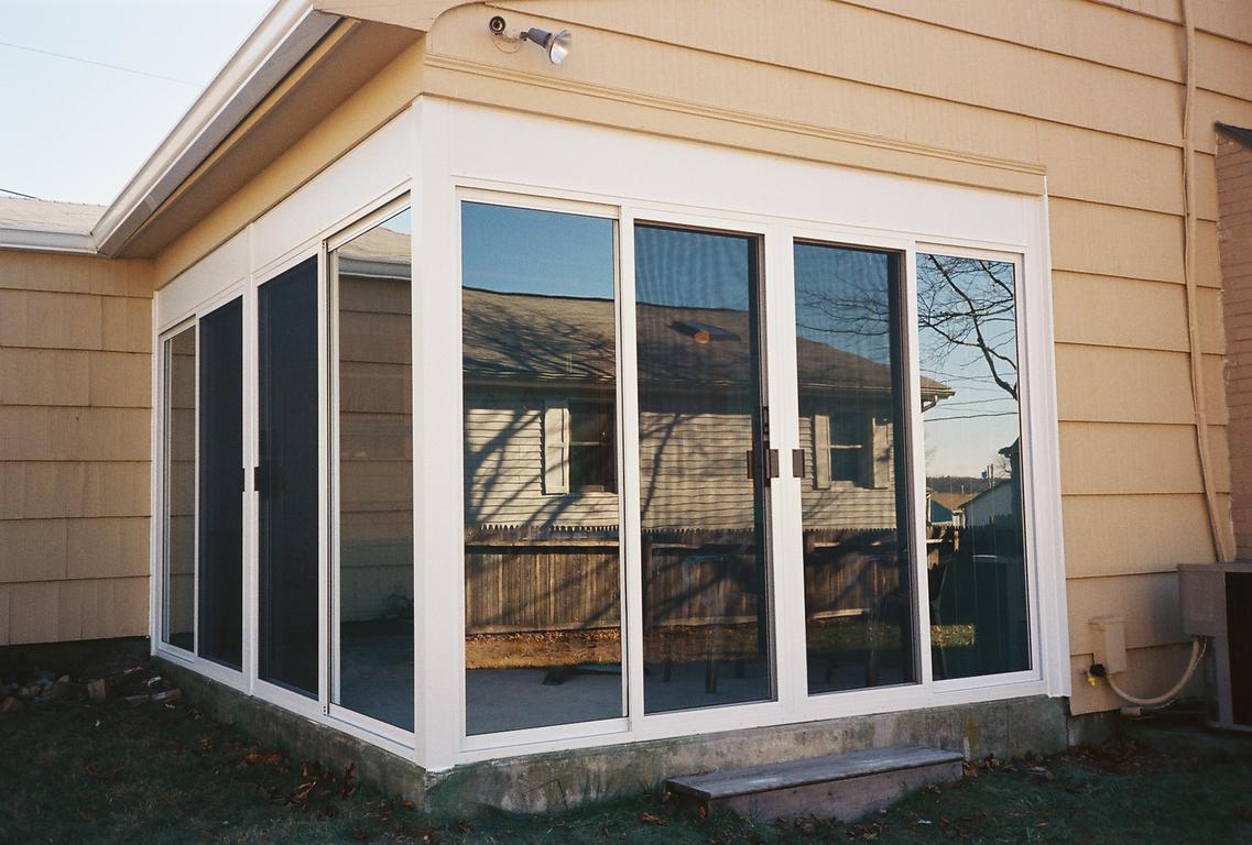 Fill-in under existing roof striped awnings outside of commercial building